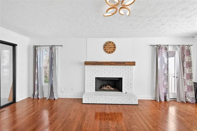 a view of a kitchen with wooden floor and a kitchen space