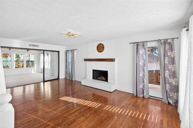 a kitchen with granite countertop a refrigerator stove top oven and sink