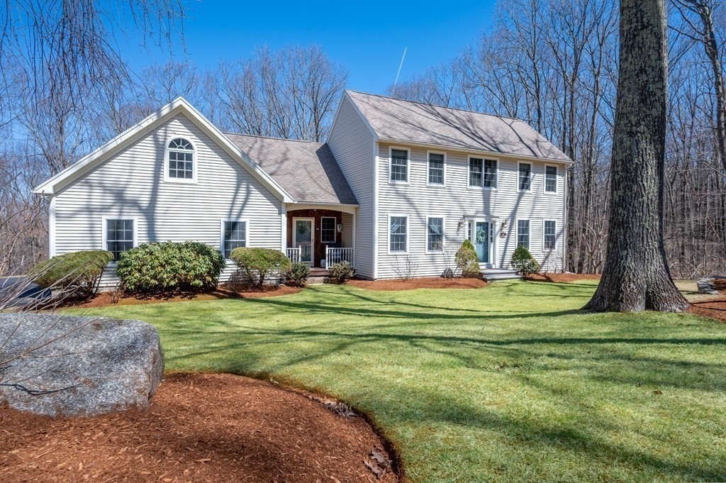 91 Hartness Road Sutton, MA 01590 - Photo 1 of 27 a front view of a house with a yard table and chairs