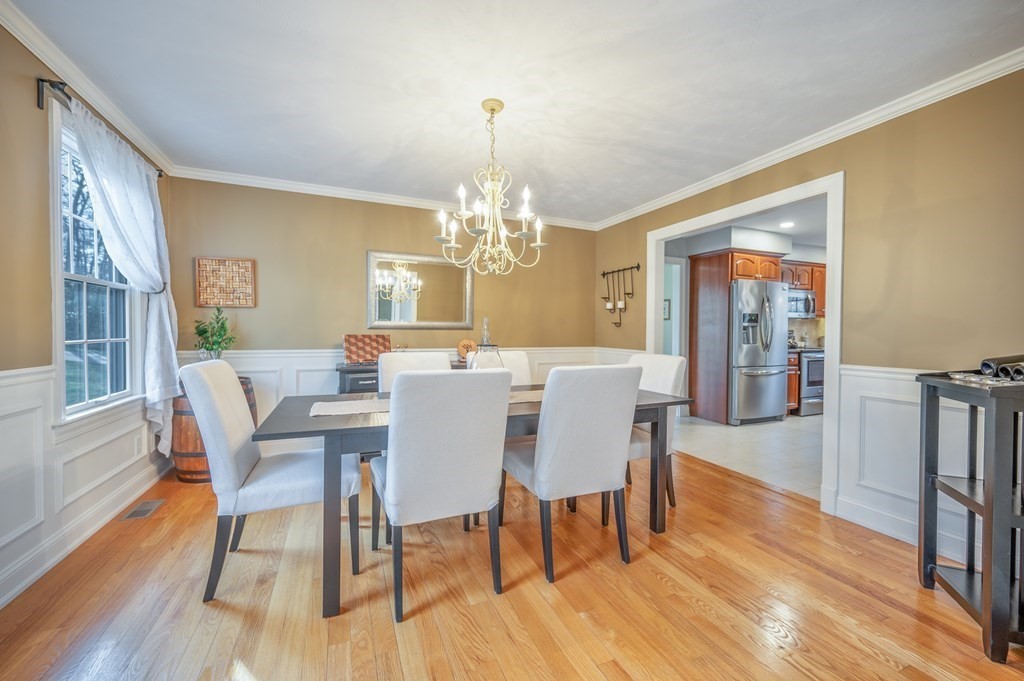 91 Hartness Road Sutton, MA 01590 - Photo 12 of 27 a view of a dining room with furniture a chandelier and wooden floor