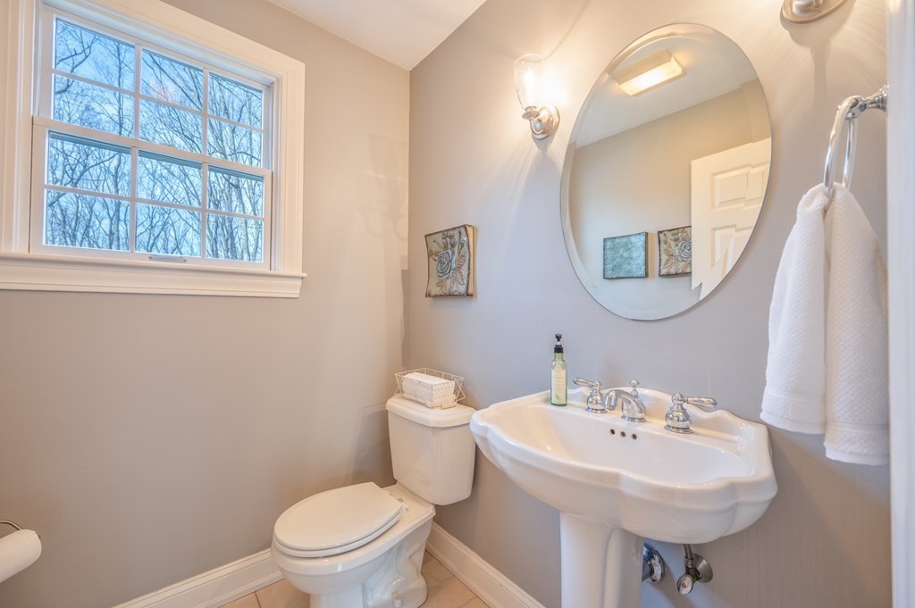 91 Hartness Road Sutton, MA 01590 - Photo 18 of 27 a bathroom with a sink a mirror and a toilet