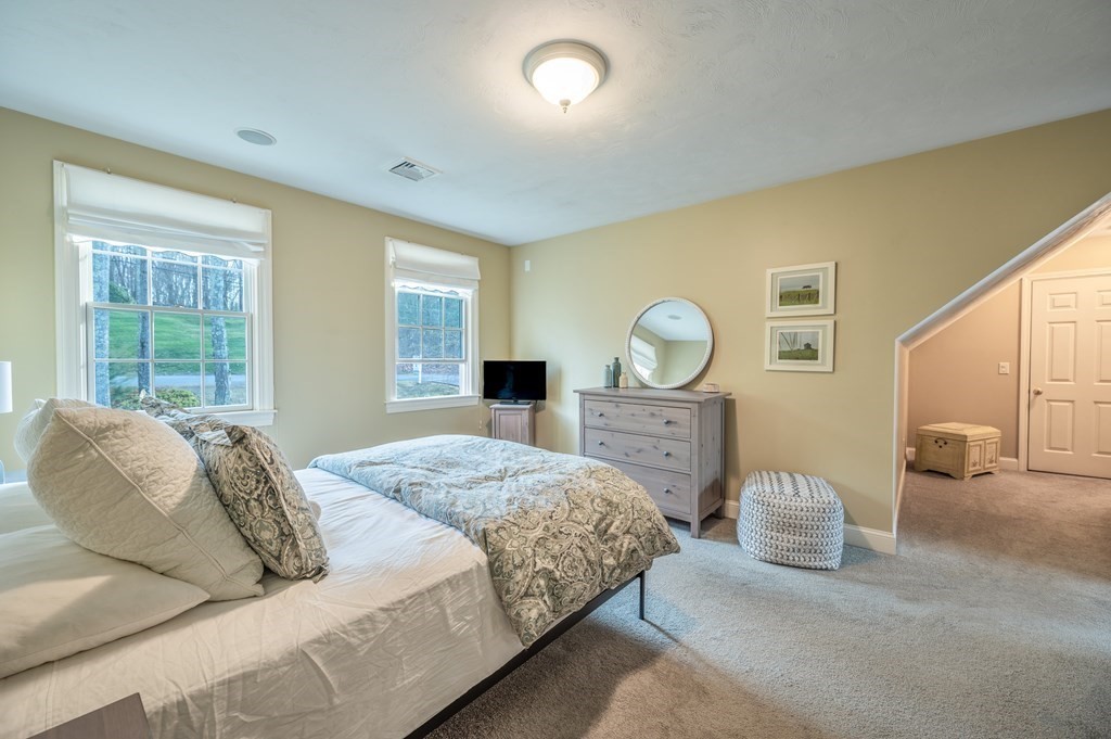 91 Hartness Road Sutton, MA 01590 - Photo 22 of 27 a bedroom with bed and a large mirror