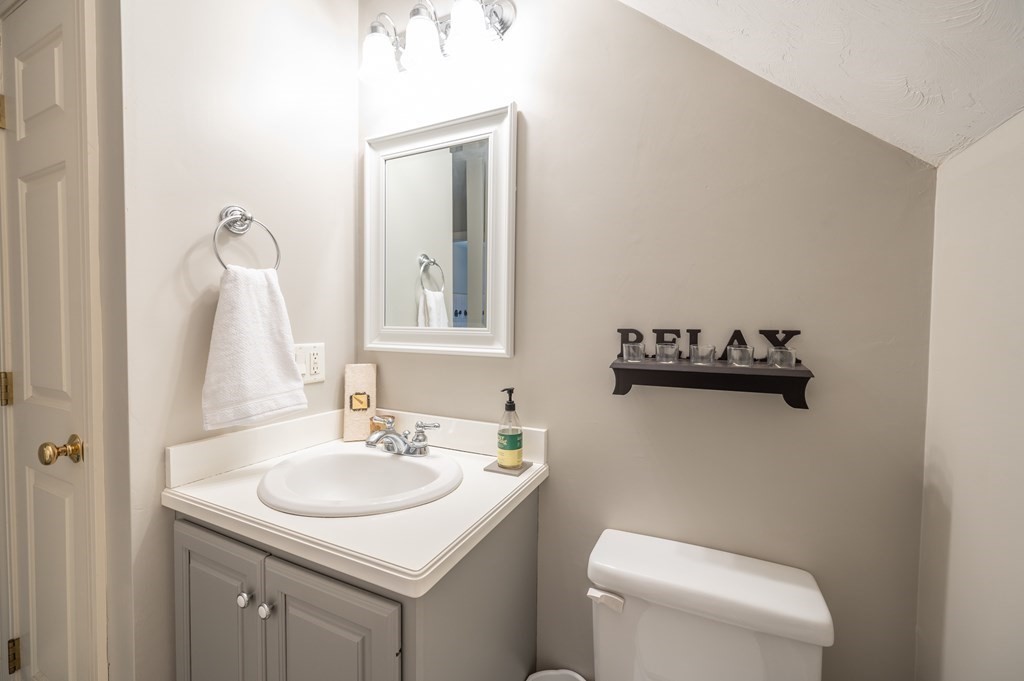 91 Hartness Road Sutton, MA 01590 - Photo 23 of 27 a bathroom with a sink toilet and mirror