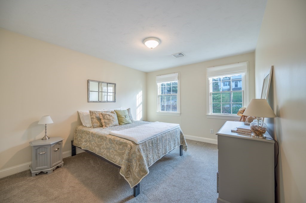 91 Hartness Road Sutton, MA 01590 - Photo 24 of 27 a bedroom with a bed and large windows