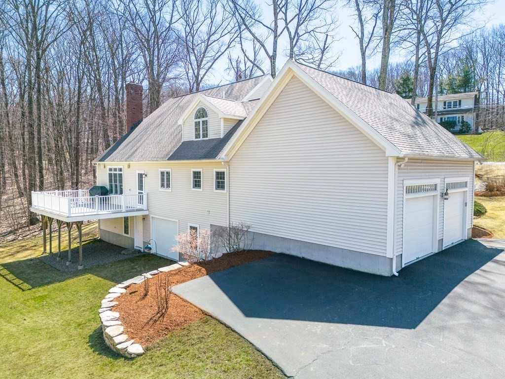 91 Hartness Road Sutton, MA 01590 - Photo 3 of 27 a view of a white house with a yard chairs and a table