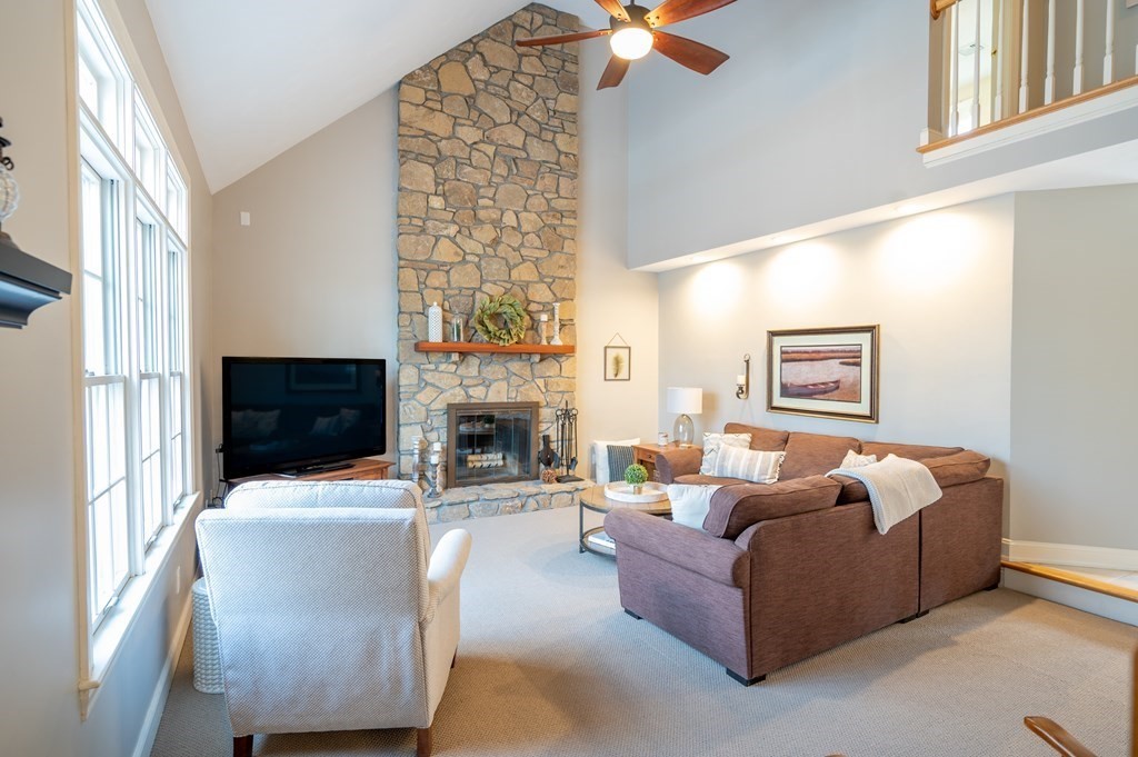 91 Hartness Road Sutton, MA 01590 - Photo 10 of 27 a living room with furniture a fireplace and a flat screen tv