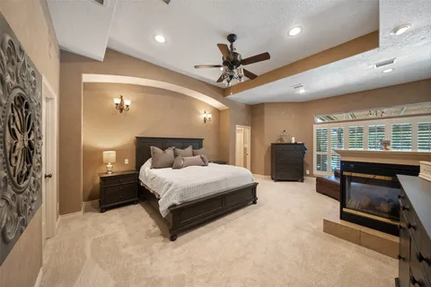 a spacious bedroom with a bed and a couch