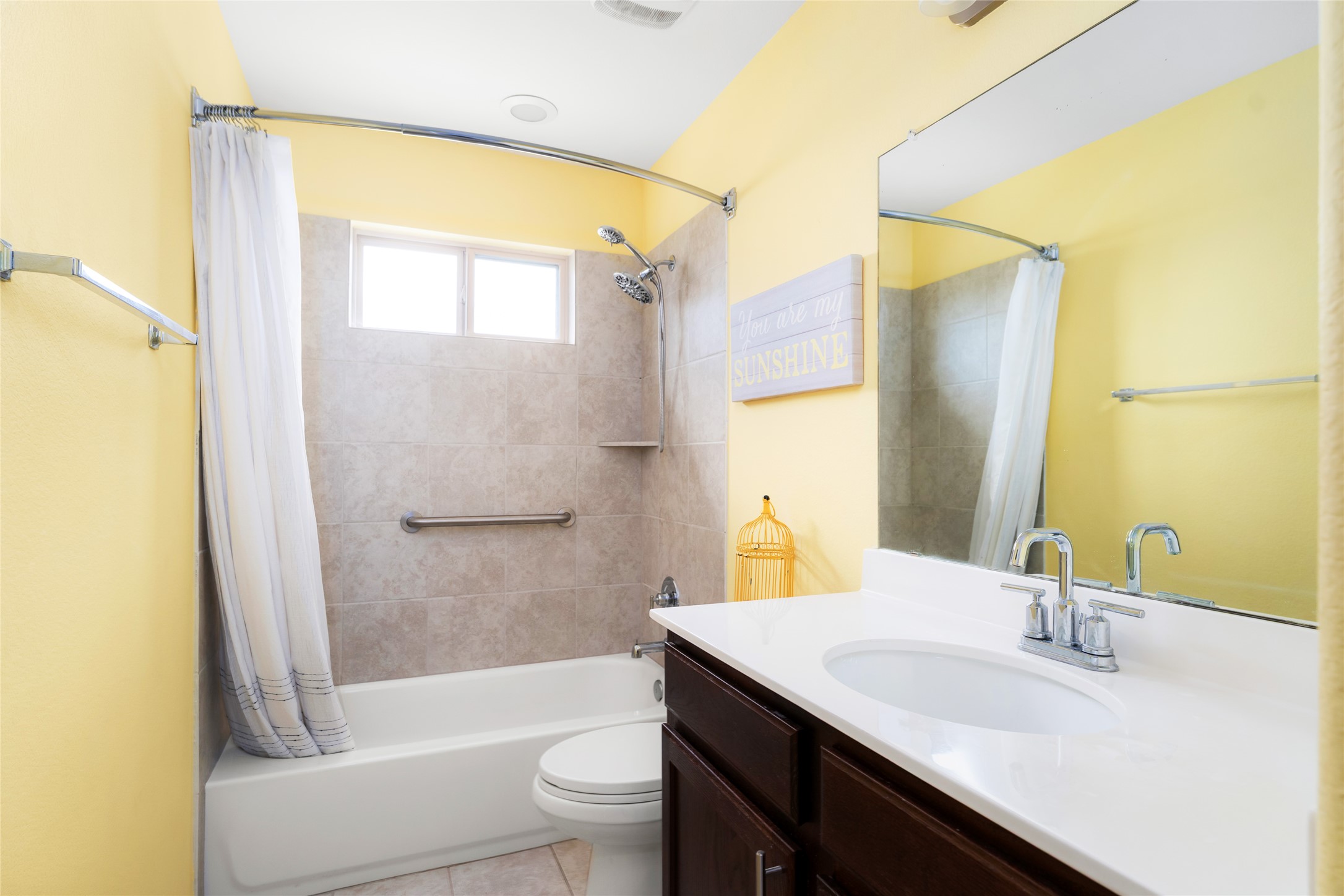 249 Wapiti Road Buda, TX 78610 - Photo 17 of 21 A well-lit bathroom with a bright vanity and convenient tub-shower combination for daily routines.