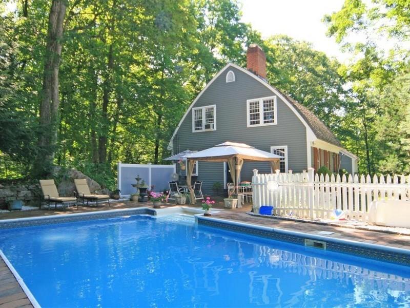 286 Limestone Road Ridgefield, CT 06877 - Photo 1 of 1 a front view of a house with yard and sitting area