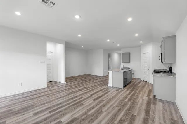 a view of a kitchen with a sink and wooden floor