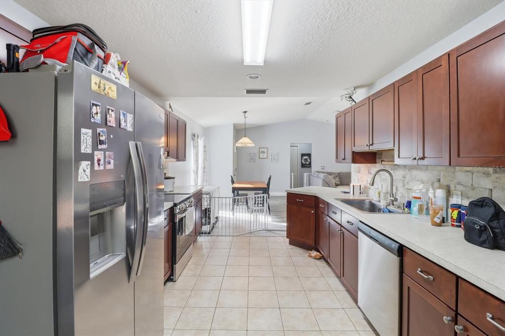 786 North Dugan Avenue Inverness, FL 34453 - Photo 21 of 44 a kitchen with stainless steel appliances granite countertop a refrigerator and a sink