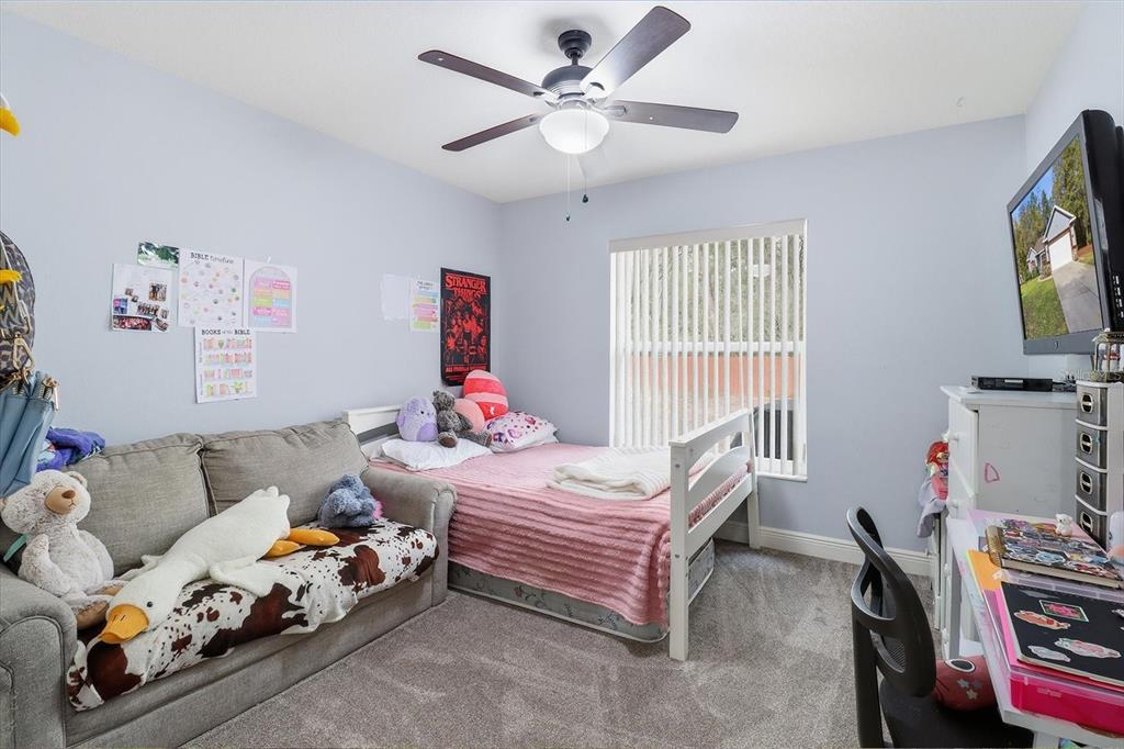 786 North Dugan Avenue Inverness, FL 34453 - Photo 22 of 44 a bedroom with furniture and a flat screen tv