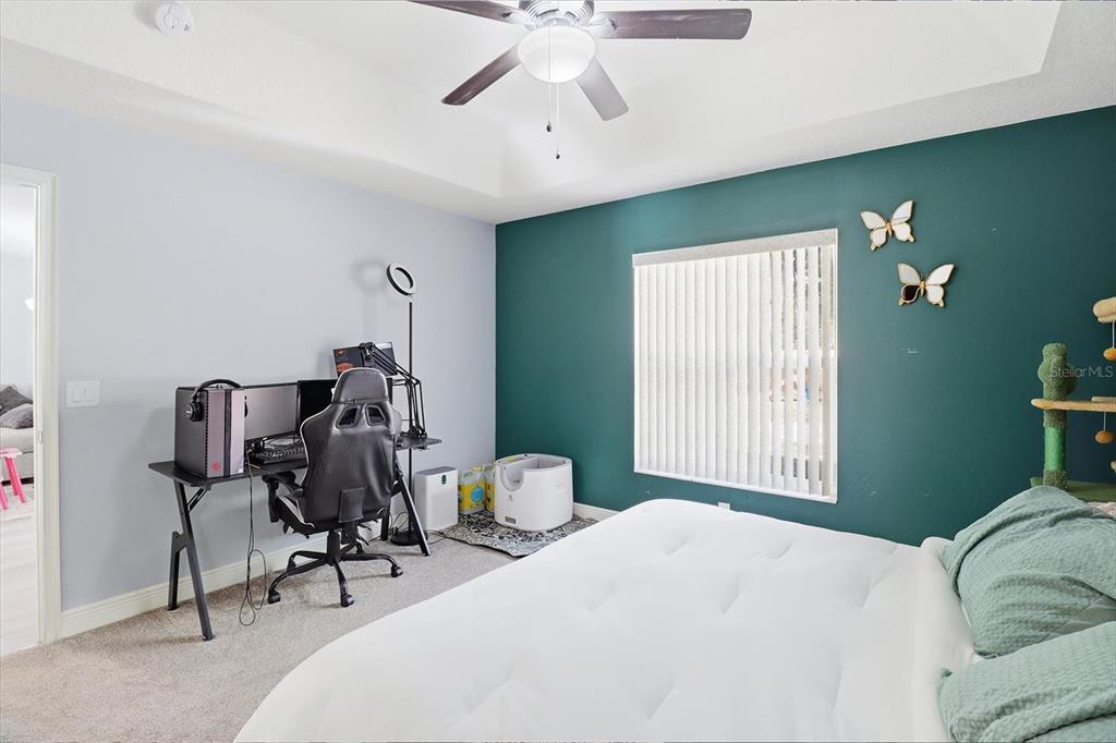 786 North Dugan Avenue Inverness, FL 34453 - Photo 30 of 44 a bedroom with a bed and a chandelier