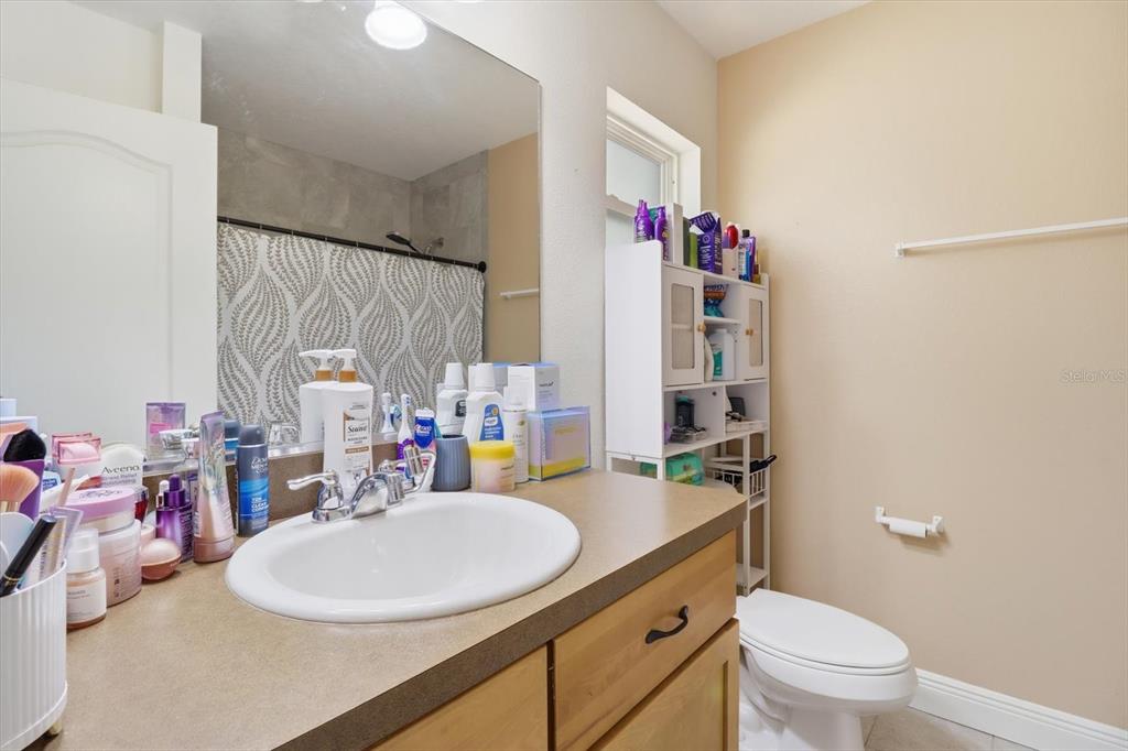 786 North Dugan Avenue Inverness, FL 34453 - Photo 33 of 44 a bathroom with a sink a toilet and shower curtain