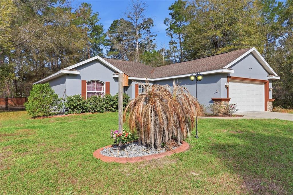 786 North Dugan Avenue Inverness, FL 34453 - Photo 4 of 44 a front view of a house with a yard and garage