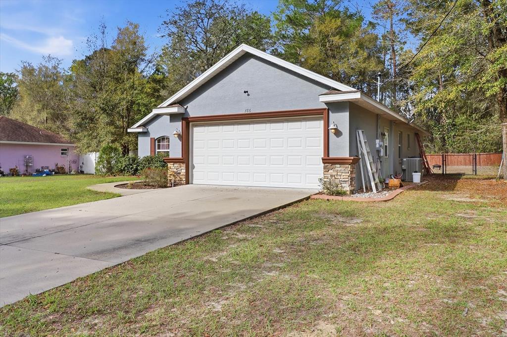 786 North Dugan Avenue Inverness, FL 34453 - Photo 5 of 44 a view of a house with a yard and garage