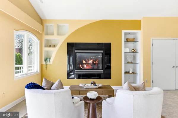 an empty room with a fireplace and window