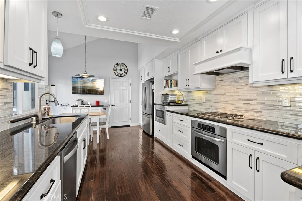 3 Nice Laguna Niguel, CA 92677 - Photo 12 of 66 a kitchen with stainless steel appliances a stove sink microwave and cabinets