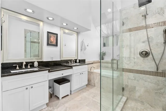 a bathroom with a granite countertop sink mirror and double