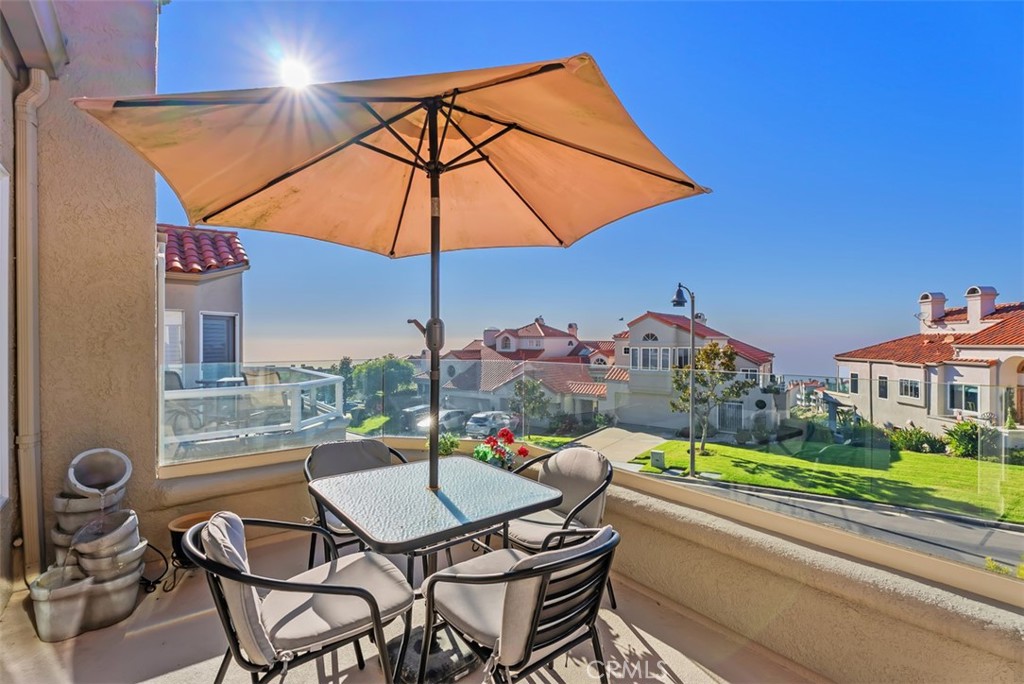 3 Nice Laguna Niguel, CA 92677 - Photo 17 of 66 a patio with a table and chairs under an umbrella