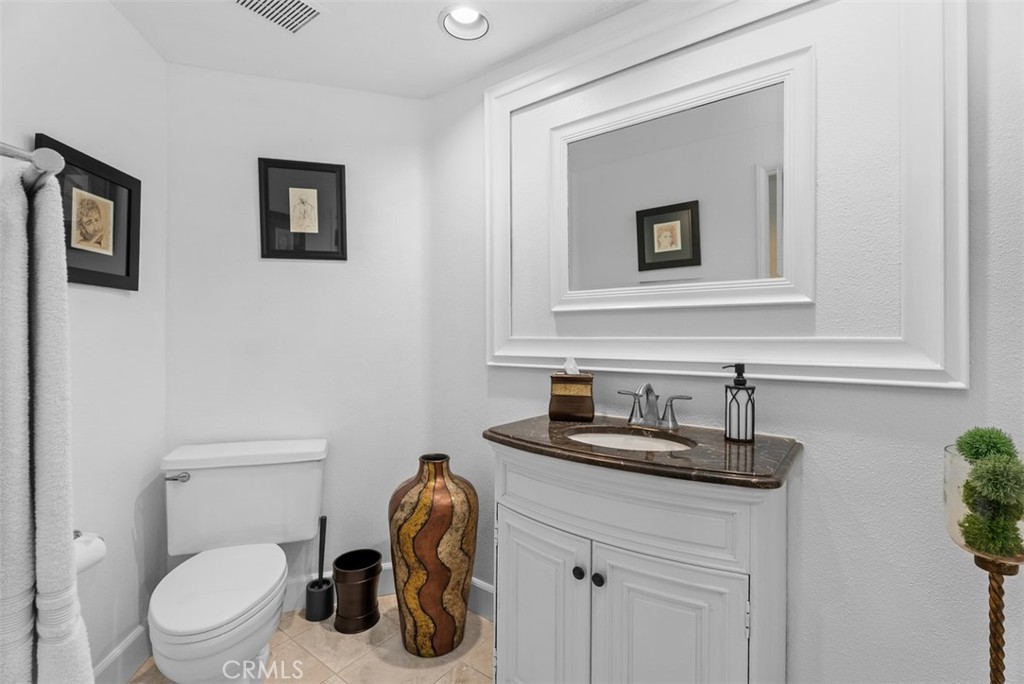 3 Nice Laguna Niguel, CA 92677 - Photo 25 of 66 a bathroom with a toilet a sink and mirror