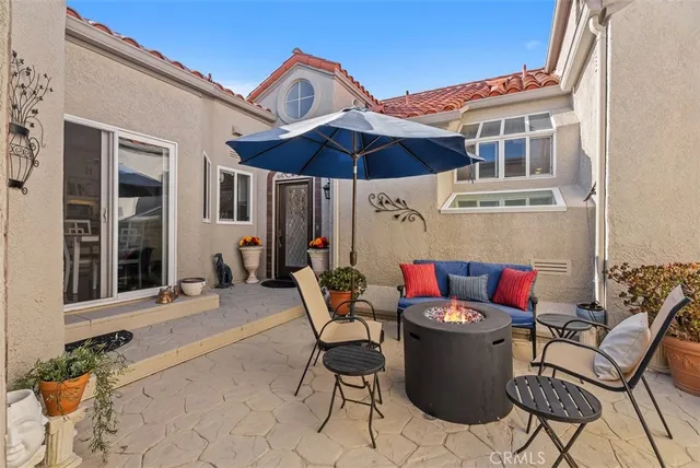 a view of a patio with table and chairs and potted plants