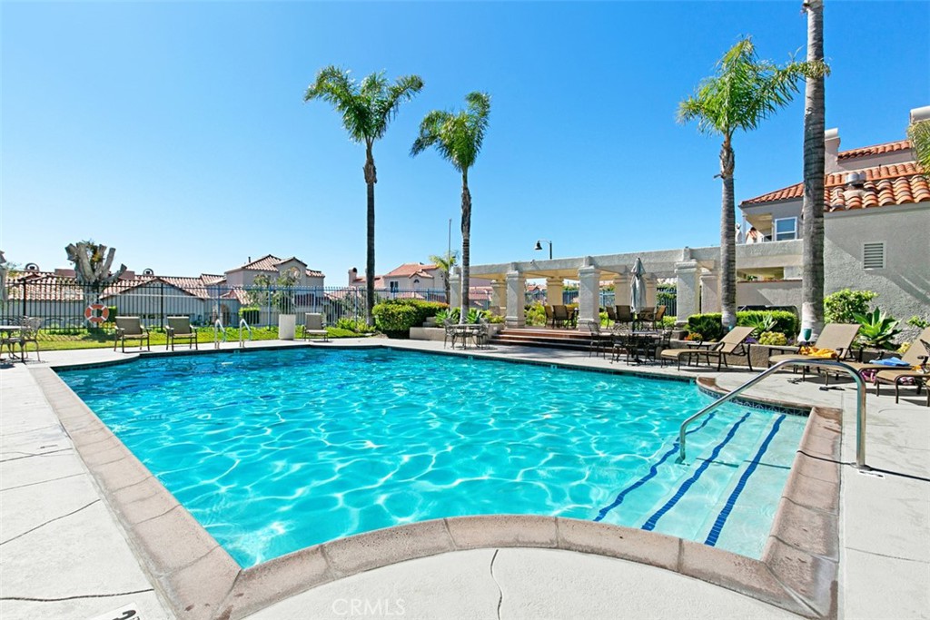 3 Nice Laguna Niguel, CA 92677 - Photo 37 of 66 a view of a swimming pool with a table and chairs