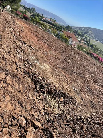 an aerial view of mountains with ocean view