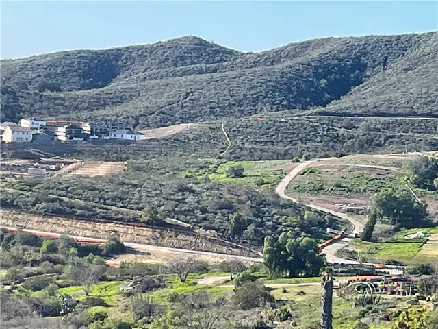 a view of a backyard with wooden fence