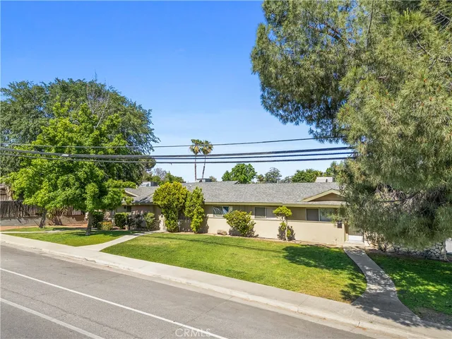 a view of a yard in front of a house with a street