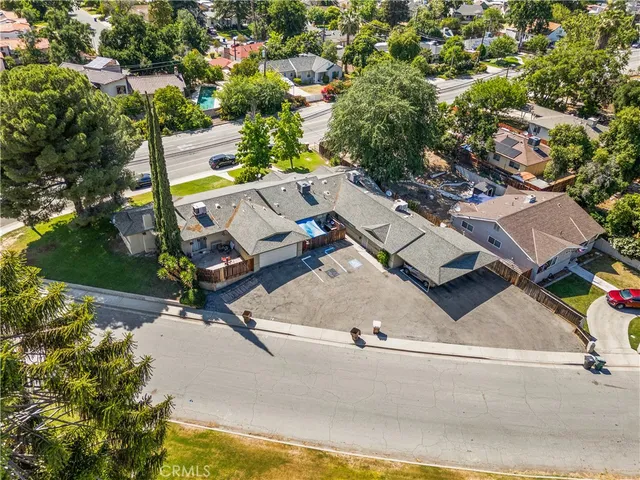 an aerial view of a house with a yard and lake view