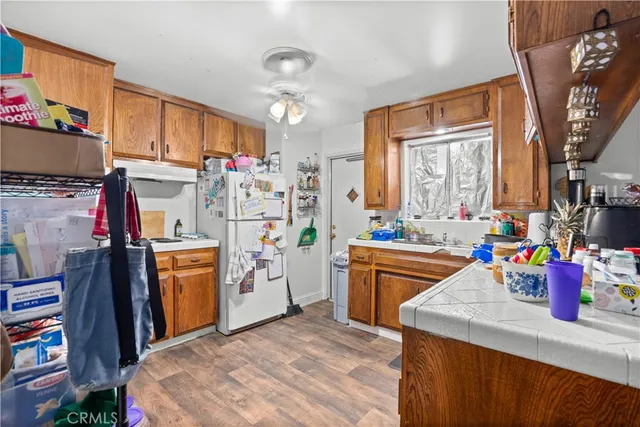 a kitchen that has a lot of white cabinets and stainless steel appliances
