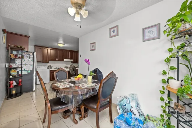 a view of a dining room with furniture and a potted plant