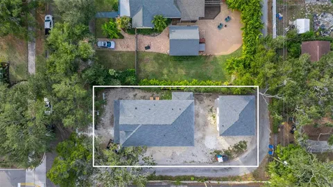 an aerial view of a house with a yard and lake view