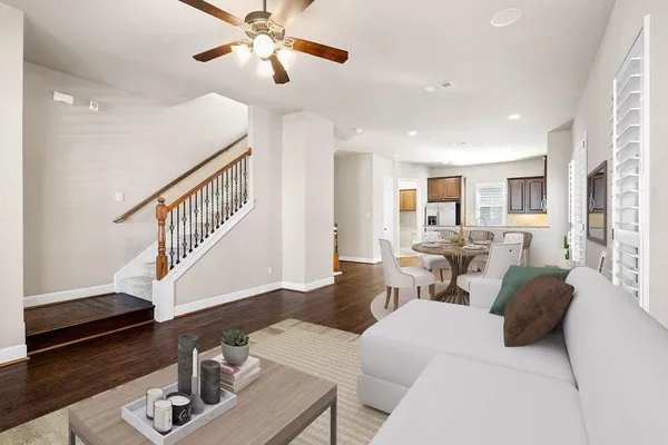 a living room with furniture and wooden floor
