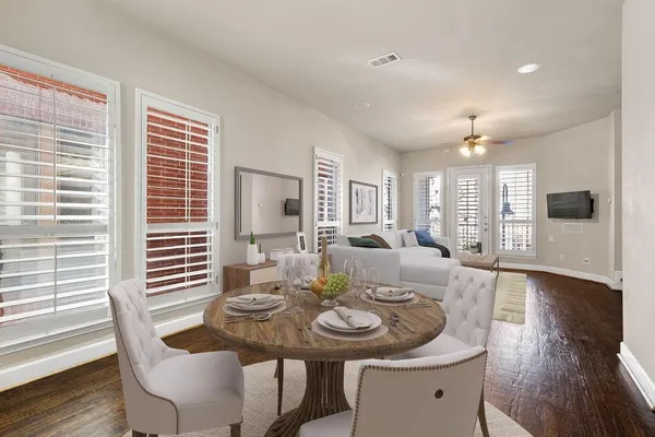 a view of a dining room with furniture and wooden floor