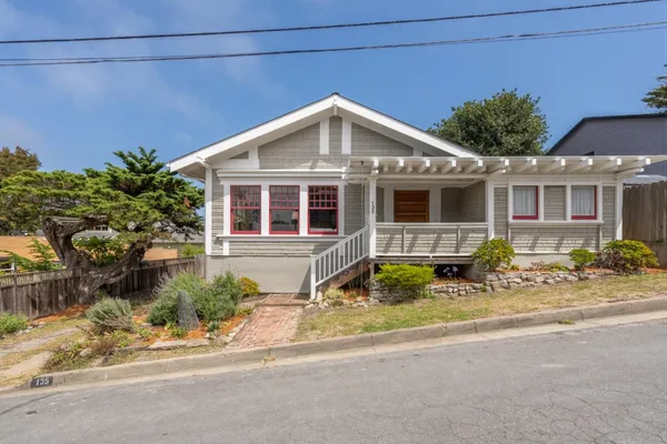 a front view of a house with garden