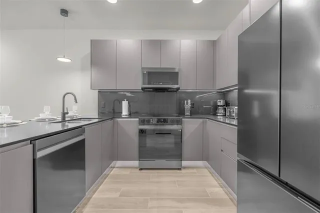 a kitchen with a sink cabinets and stainless steel appliances