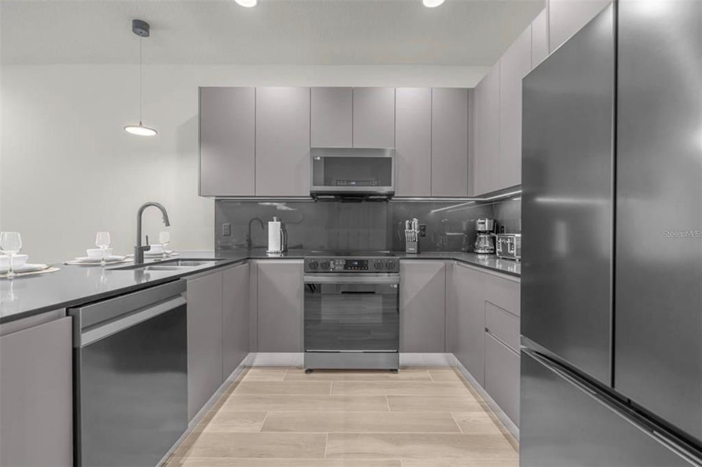 1411 Serendipity Lane Clermont, FL 34714 - Photo 13 of 15 a kitchen with a sink cabinets and stainless steel appliances