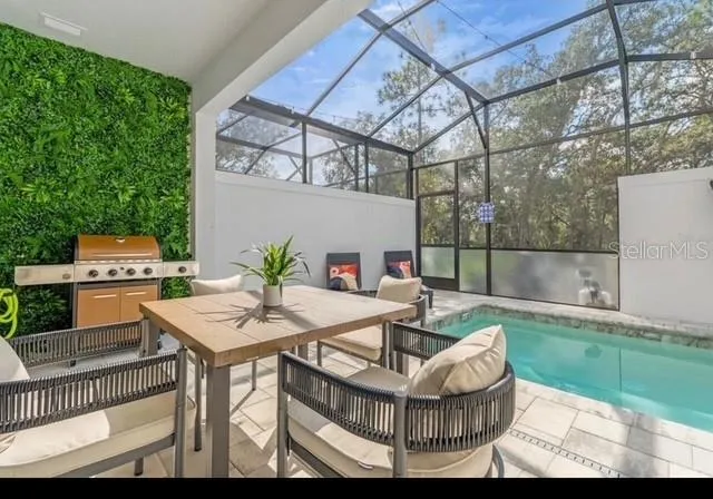 a view of a patio with table and chairs a barbeque and potted plants