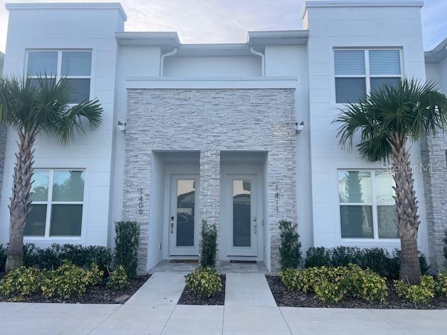 1411 Serendipity Lane Clermont, FL 34714 - Photo 3 of 15 front view of a house with potted plants