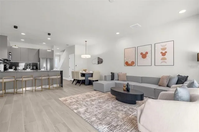 a living room with furniture and kitchen view