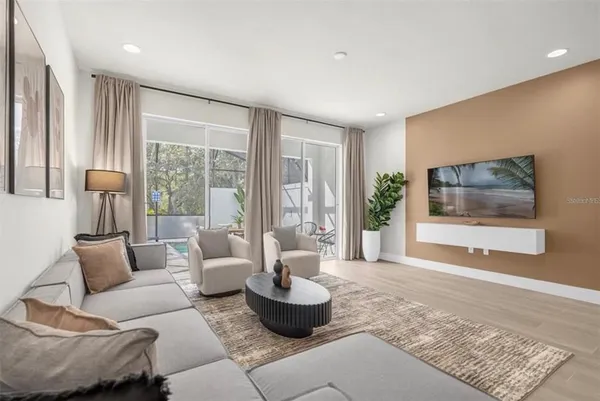 a living room with furniture and a potted plant