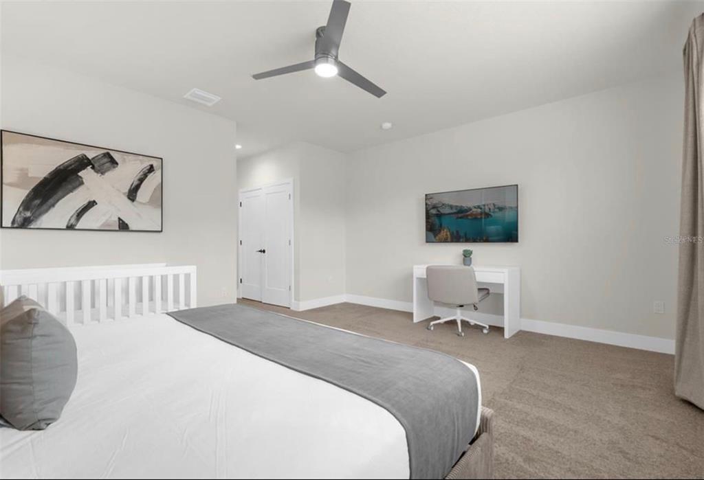 1411 Serendipity Lane Clermont, FL 34714 - Photo 7 of 15 a bedroom with a bed and a chair