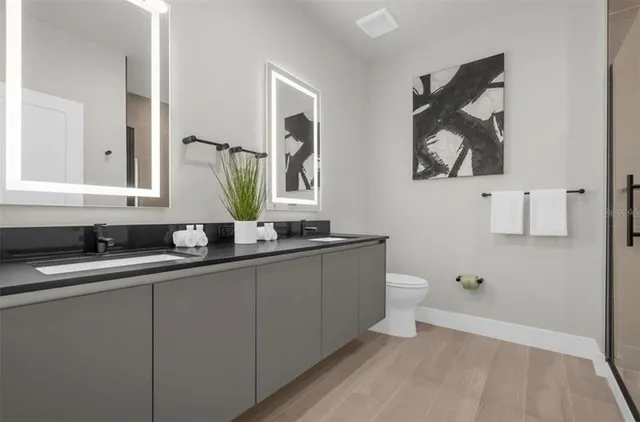 a bathroom with a toilet a sink and mirror