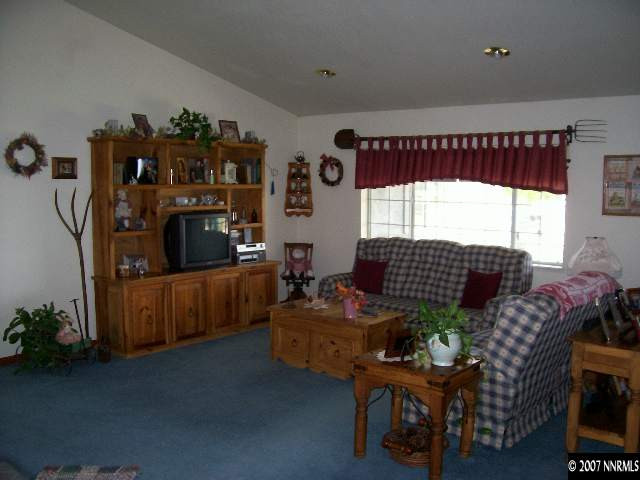 3368 Rice Road Fallon, NV 89406 - Photo 2 of 6 a living room with furniture and a floor to ceiling window