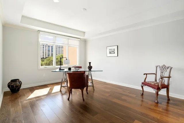 a dining room with furniture and wooden floor