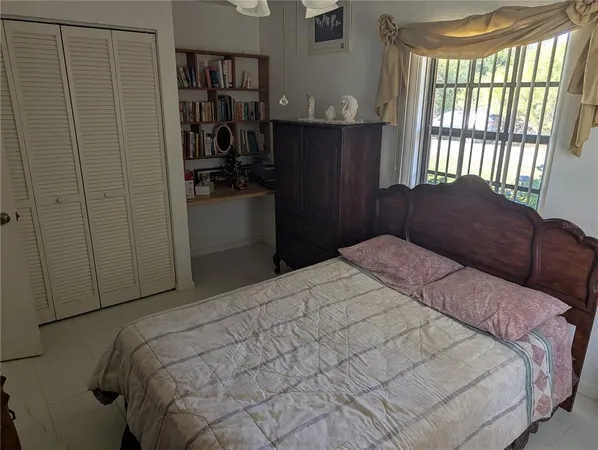 a bedroom with a bed and a window