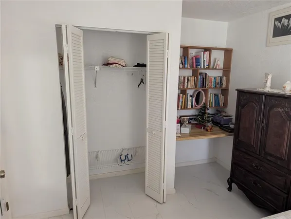 a view of walk in closet with clothes