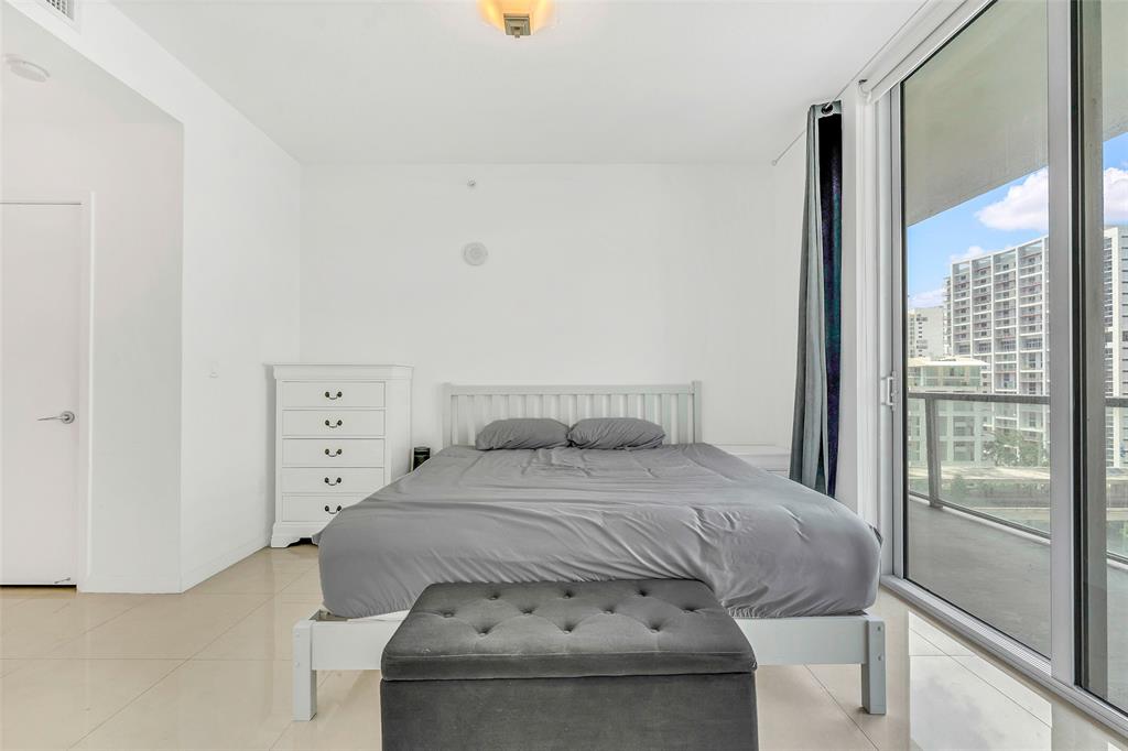1111 Southwest 1st Avenue, Unit 1224N Miami, FL 33130 - Photo 11 of 37 a bedroom with a bed and glass door
